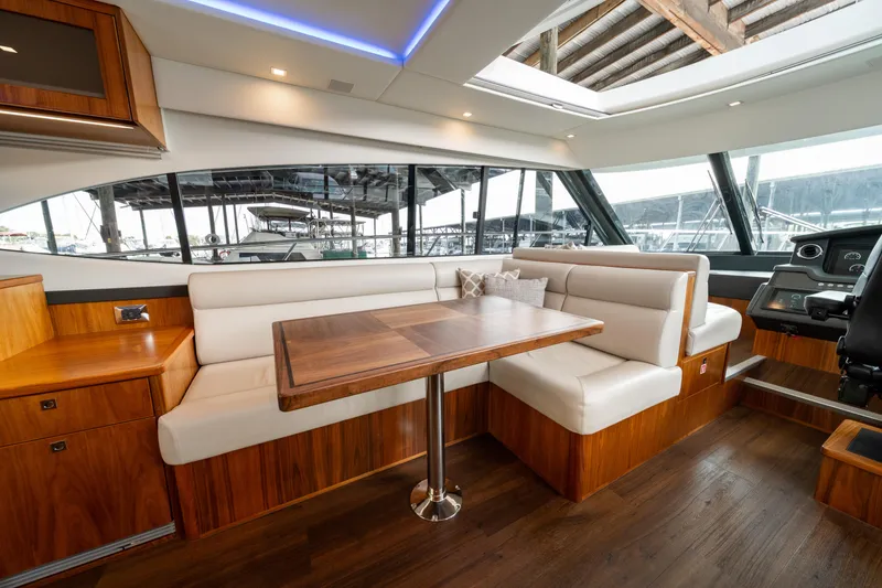 Slide: The Image of Luxurious interior of 2018 Riviera 5400 Sport Yacht with elegant seating and wooden finishes. - 34