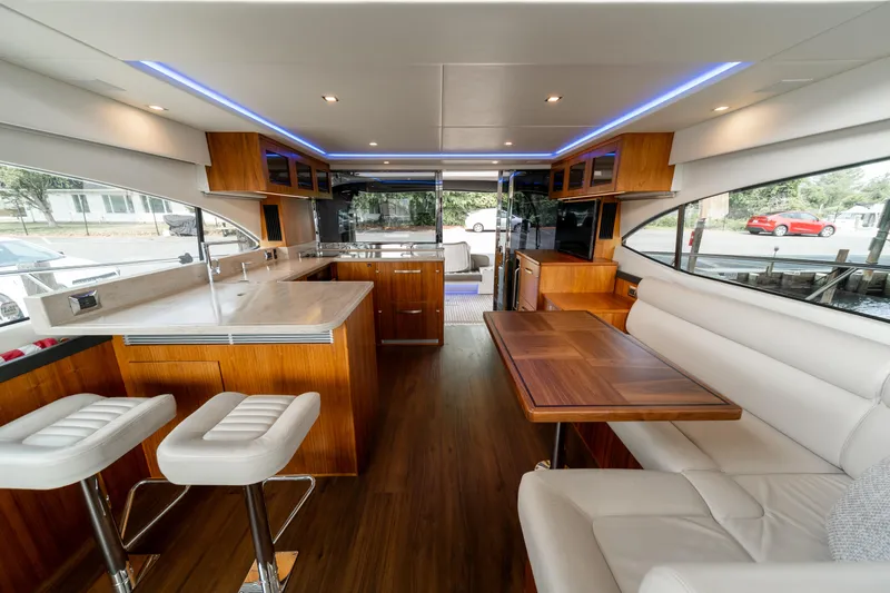 Slide: The Image of Luxurious interior of 2018 Riviera 5400 Sport Yacht with modern kitchen and seating area. - 36