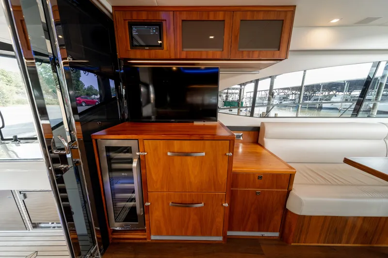 Slide: The Image of Luxurious interior of 2018 Riviera 5400 Sport Yacht with wood cabinetry and seating. - 38