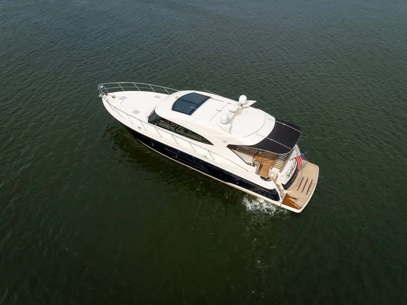 Slide: The Image of 2018 Riviera 5400 Sport Yacht cruising on open water. - 4