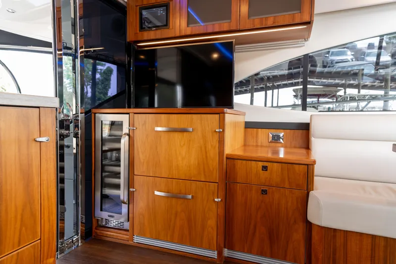 Slide: The Image of 2018 Riviera 5400 Sport Yacht interior with wooden cabinetry and modern appliances. - 40