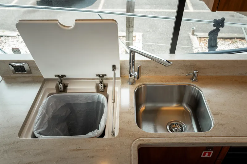 Slide: The Image of Modern yacht kitchen with sink and concealed trash bin, Riviera 5400 Sport Yacht 2018 model. - 44
