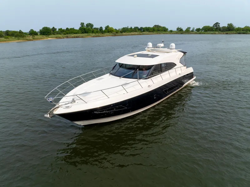 Slide: The Image of 2018 Riviera 5400 Sport Yacht cruising on a calm river. - 7
