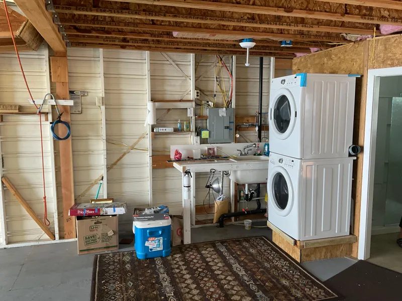 Slide: The Image of Laundry area in a 1980 custom boathouse with stacked washer and dryer. - 10