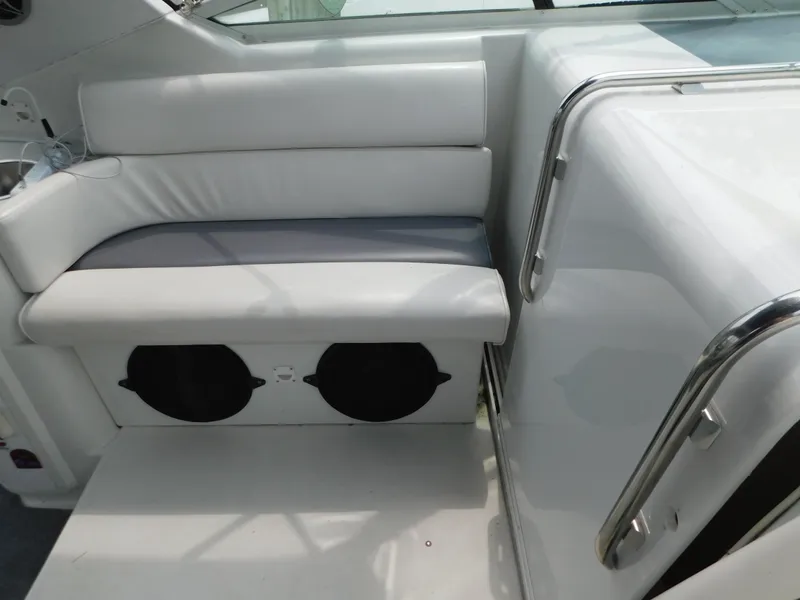 Slide: The Image of 1991 Chris-Craft 302 Crowne boat interior with white seating and stainless steel railings. - 11