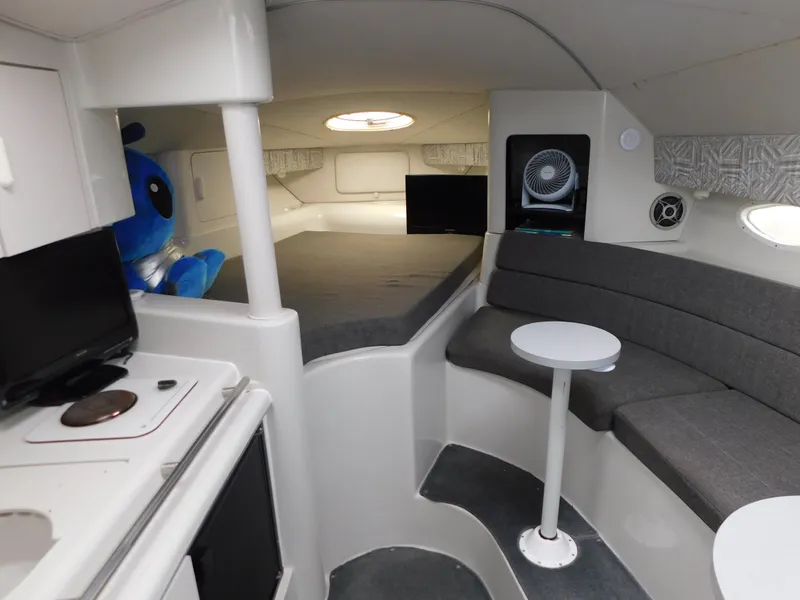 Slide: The Image of Interior of 1991 Chris-Craft 302 Crowne boat with seating, bed, and kitchenette. - 13