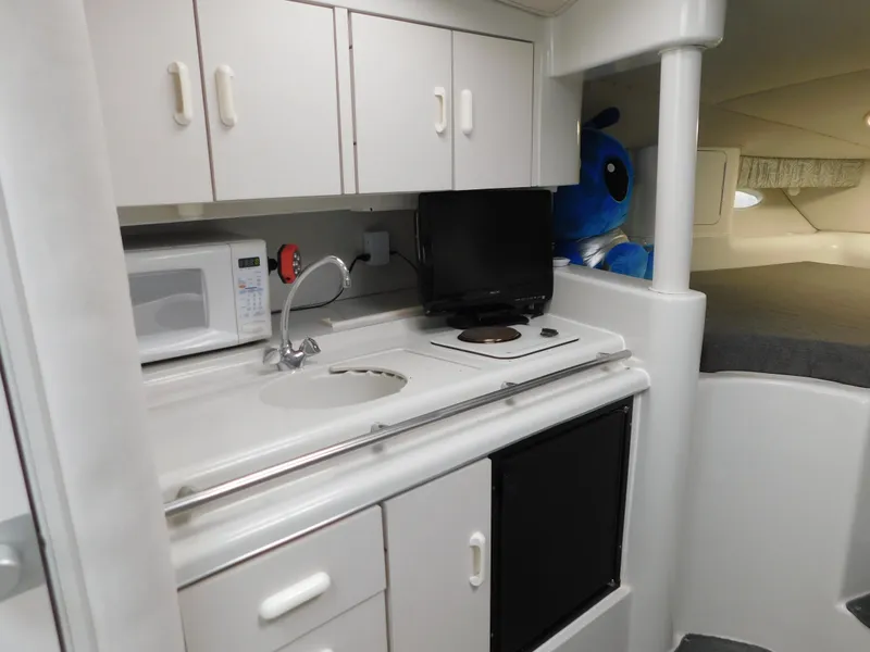 Slide: The Image of Interior of 1991 Chris-Craft 302 Crowne boat with kitchenette and sleeping area. - 14