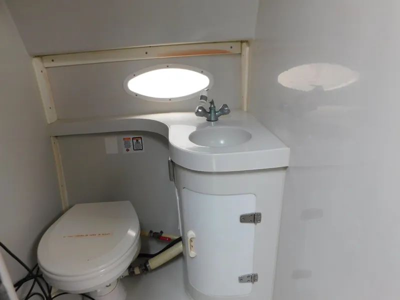 Slide: The Image of 1991 Chris-Craft 302 Crowne boat bathroom with sink and toilet. - 17