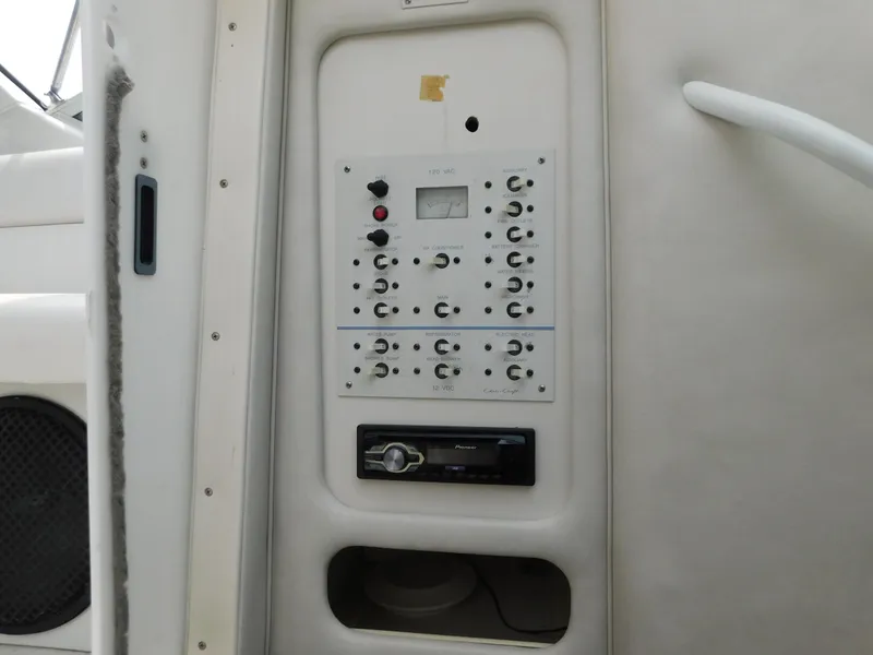 Slide: The Image of 1991 Chris-Craft 302 Crowne control panel with audio system and switches. - 18