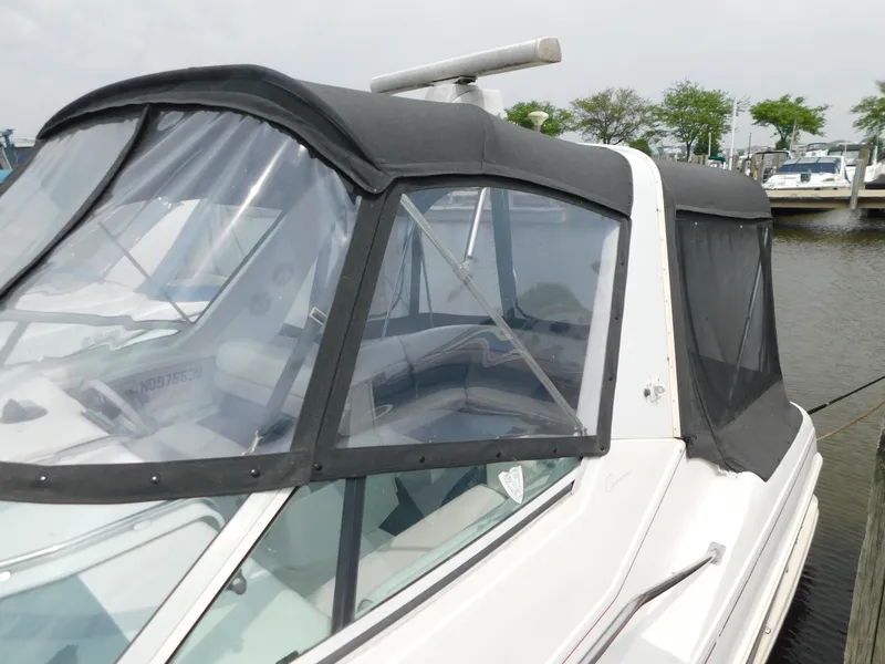 Slide: The Image of 1991 Chris-Craft 302 Crowne boat with black canopy docked at marina. - 5