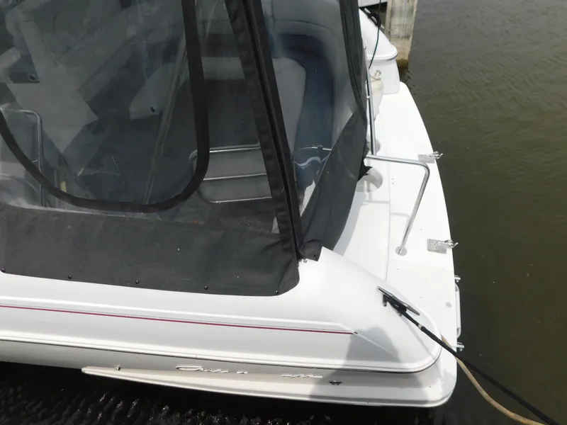 Slide: The Image of 1991 Chris-Craft 302 Crowne boat docked, featuring a covered cockpit and sleek design. - 6