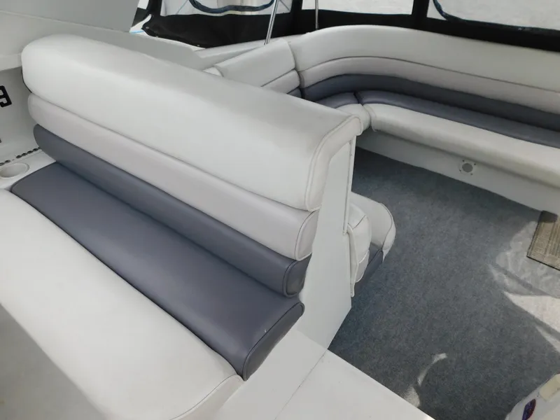 Slide: The Image of 1991 Chris-Craft 302 Crowne boat interior with gray and white seating. - 9