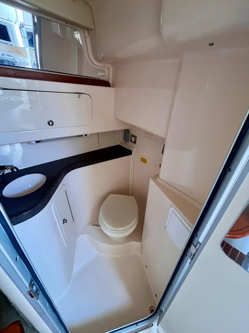 Slide: The Image of 2007 Grady-White Express 330 boat bathroom interior with sink and toilet. - 10