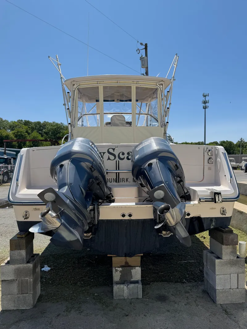 Slide: The Image of 2007 Grady-White Express 330 boat with dual outboard motors on blocks. - 2