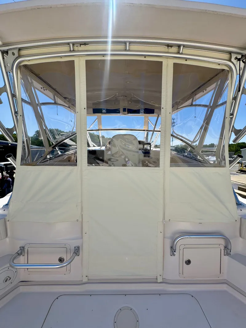 Slide: The Image of 2007 Grady-White Express 330 boat cockpit with clear enclosure and seating. - 5