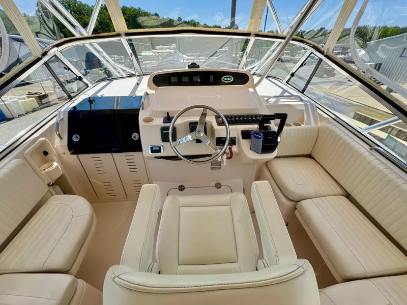 Slide: The Image of 2007 Grady-White Express 330 boat cockpit with steering wheel and seating. - 7