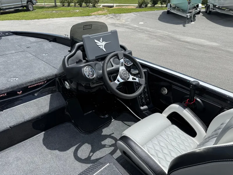 Slide: The Image of Interior of 2026 Phoenix 819 ZXL boat with modern steering and dashboard. - 9