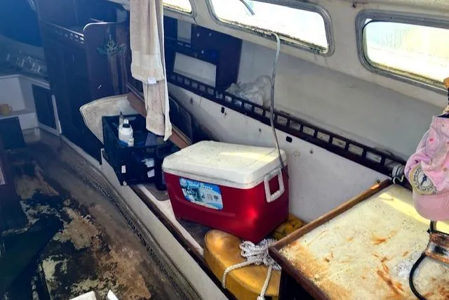 Slide: The Image of Interior of a 1977 Catalina 30 Tall Rig sailboat with cooler and storage. - 7