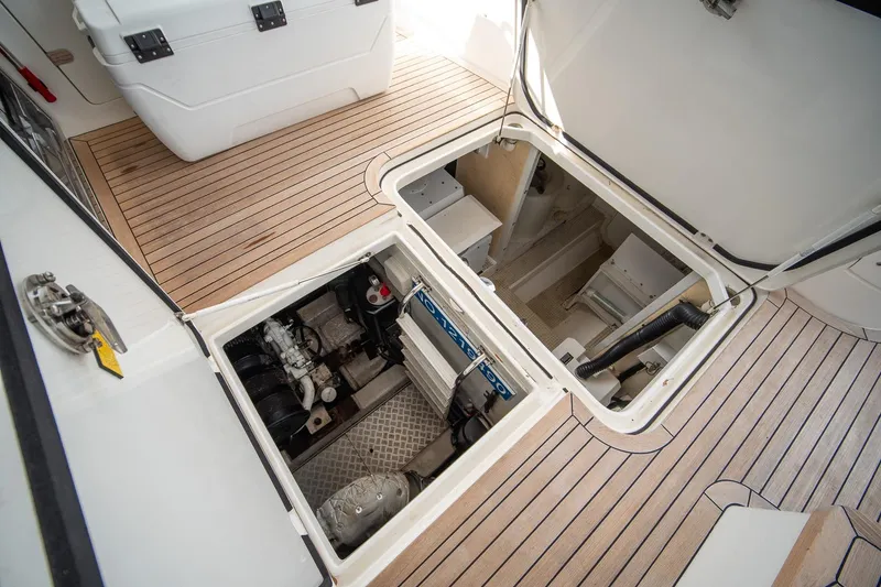 Slide: The Image of Engine compartment of 2009 Princess F54 yacht with open hatches on teak deck. - 102