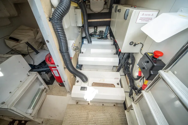 Slide: The Image of Engine room of a 2009 Princess F54 yacht, featuring equipment and safety gear. - 104