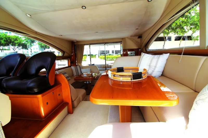 Slide: The Image of Luxurious interior of a 2009 Princess F54 yacht with elegant seating and wooden table. - 13