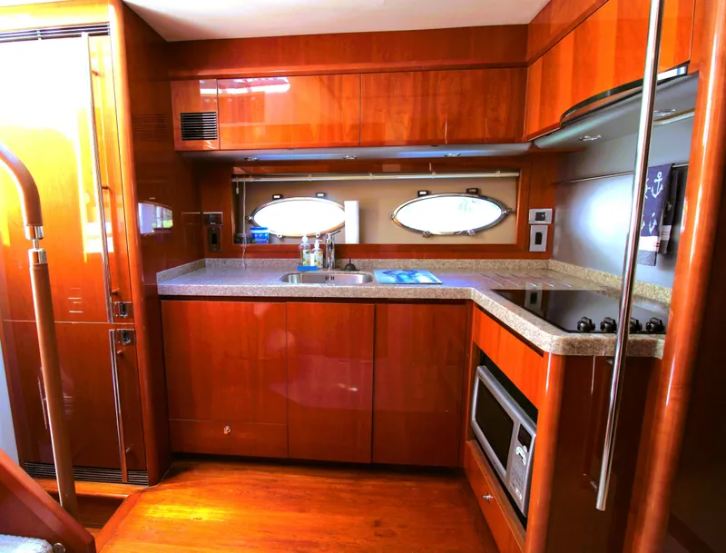 Slide: The Image of Luxurious yacht kitchen interior with wood cabinetry, modern appliances, and oval porthole window. Princess F54, 2009. - 14