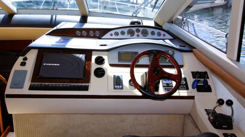 Slide: The Image of Luxurious 2009 Princess F54 yacht cockpit with advanced navigation controls and steering wheel. - 2