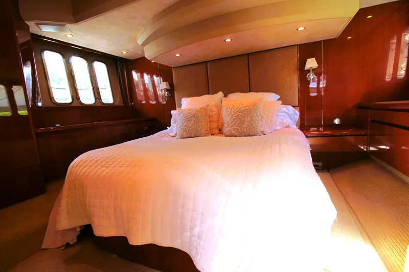 Slide: The Image of Luxurious bedroom interior of 2009 Princess F54 yacht with elegant bedding and wood paneling. - 23
