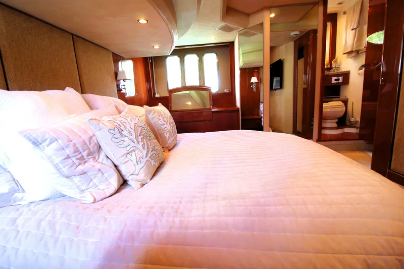 Slide: The Image of Luxurious bedroom interior on 2009 Princess F54 yacht with elegant bedding and ensuite bathroom. - 24