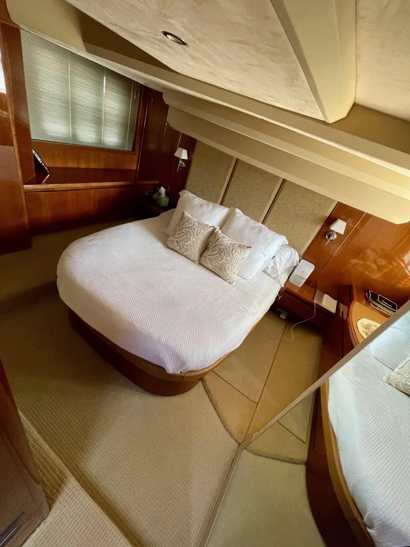 Slide: The Image of Luxurious bedroom interior of 2009 Princess F54 yacht with elegant bedding and wood accents. - 28