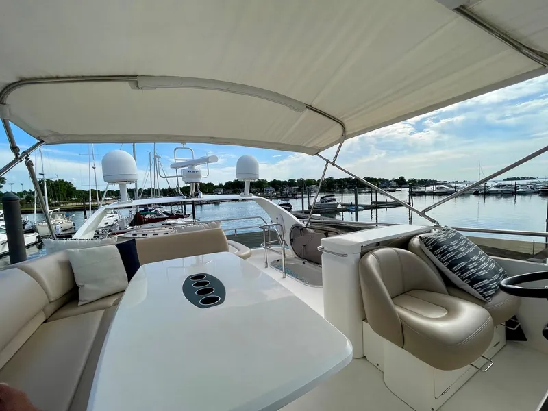 Slide: The Image of Luxurious 2009 Princess F54 yacht interior with seating and table, docked at marina. - 3