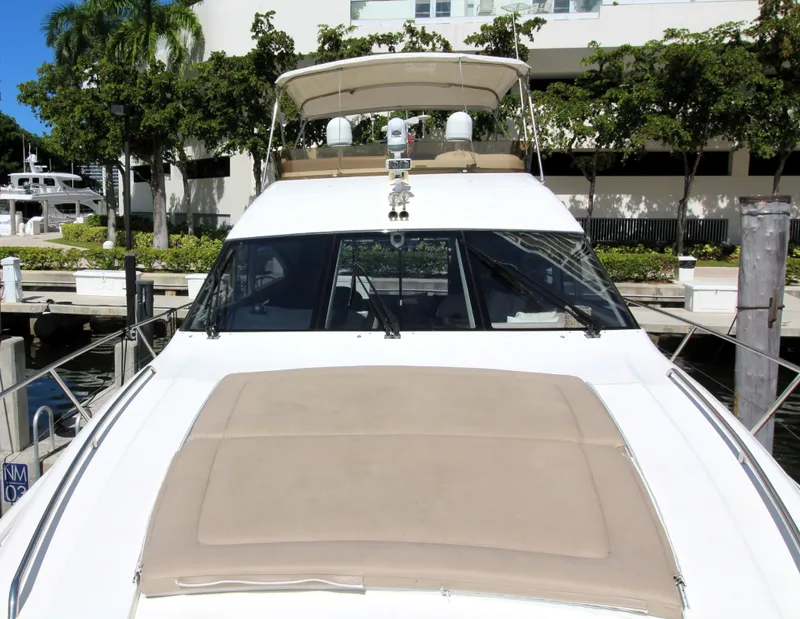 Slide: The Image of 2009 Princess F54 yacht docked at marina with lush greenery. - 38