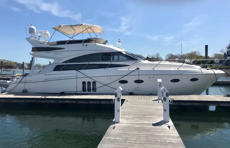 Slide: The Image of Luxury 2009 Princess F54 yacht docked at marina under clear blue sky. - 41