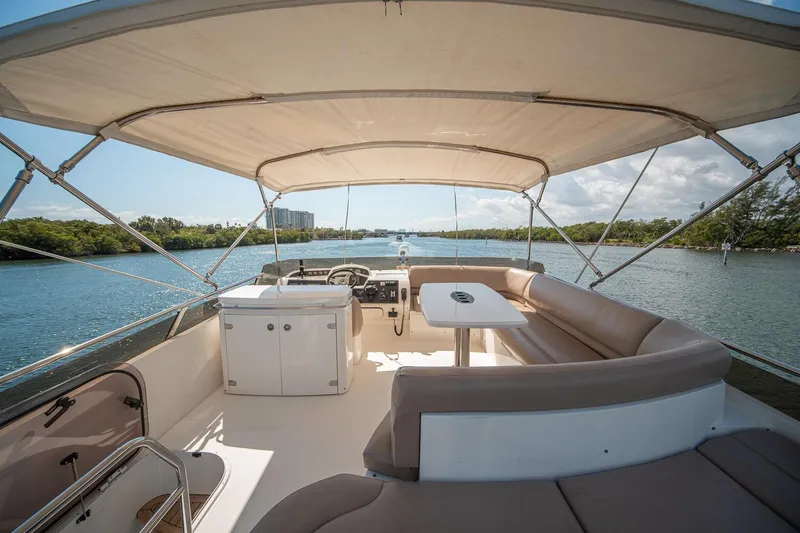 Slide: The Image of Luxurious 2009 Princess F54 yacht interior with spacious seating and scenic waterway view. - 46