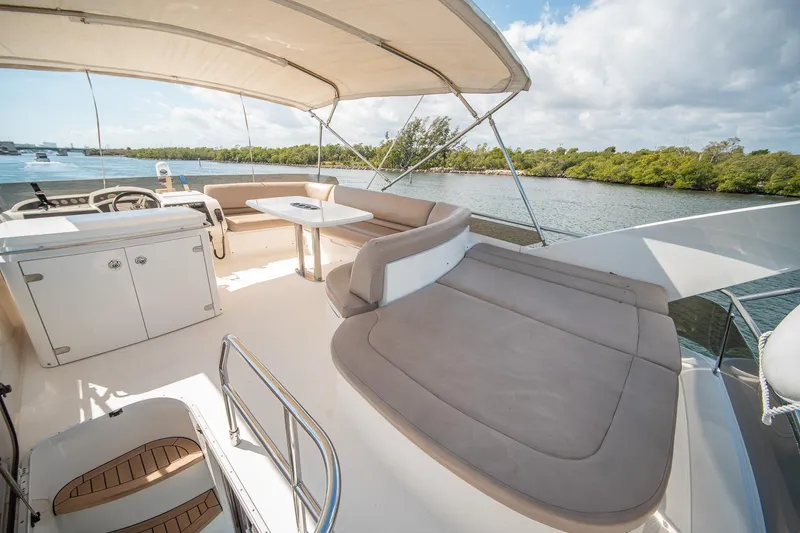 Slide: The Image of Luxurious 2009 Princess F54 yacht deck with seating, table, and scenic water view. - 47