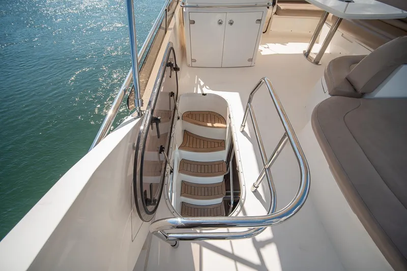 Slide: The Image of Luxurious 2009 Princess F54 yacht deck with elegant seating and staircase. - 48