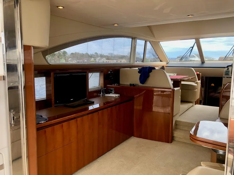 Slide: The Image of Luxurious interior of 2009 Princess F54 yacht with elegant wood finishes and seating area. - 6