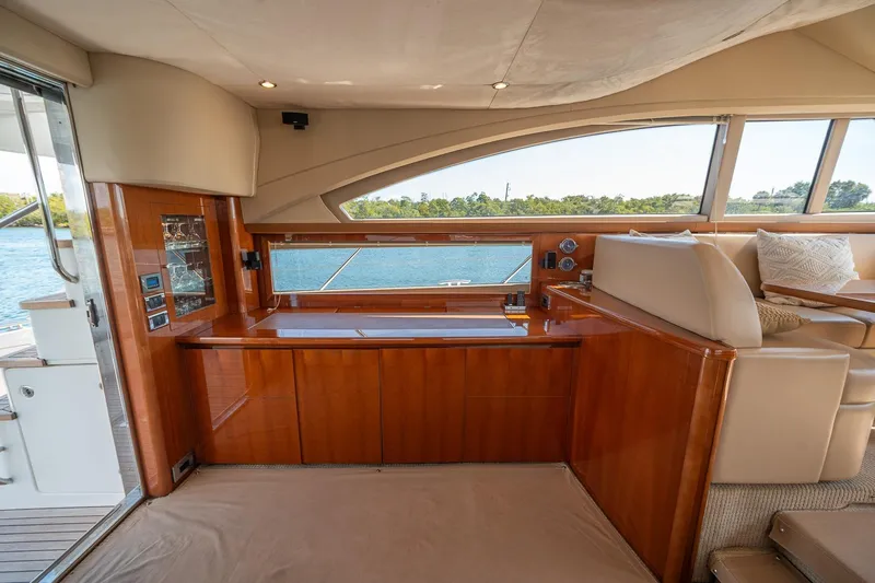 Slide: The Image of Luxurious interior of 2009 Princess F54 yacht with elegant wood finish and scenic window view. - 63