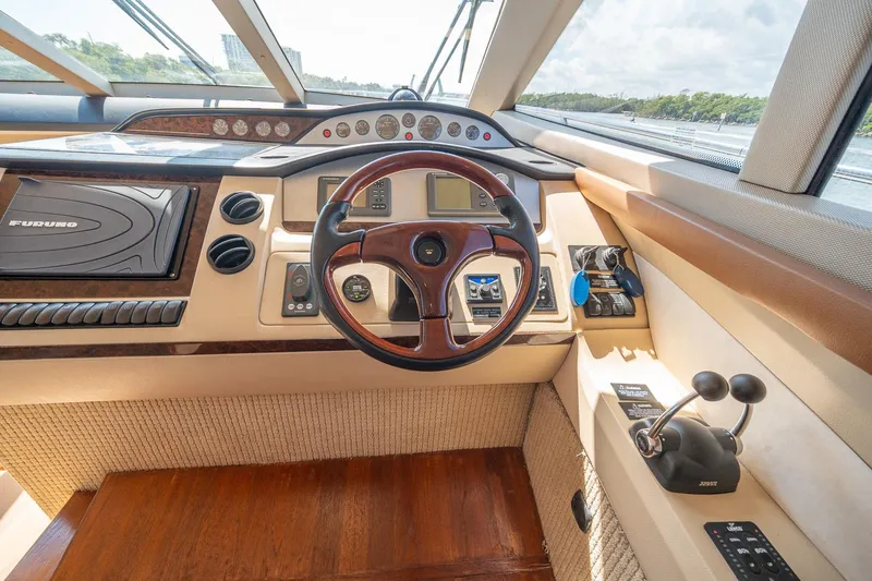 Slide: The Image of Helm of 2009 Princess F54 yacht with steering wheel and navigation controls. - 70
