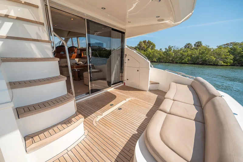 Slide: The Image of Luxurious 2009 Princess F54 yacht deck with seating, stairs, and scenic water view. - 83