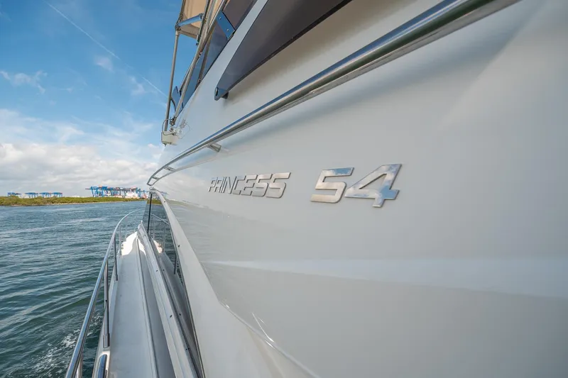Slide: The Image of Side view of a 2009 Princess F54 yacht cruising on open water. - 87