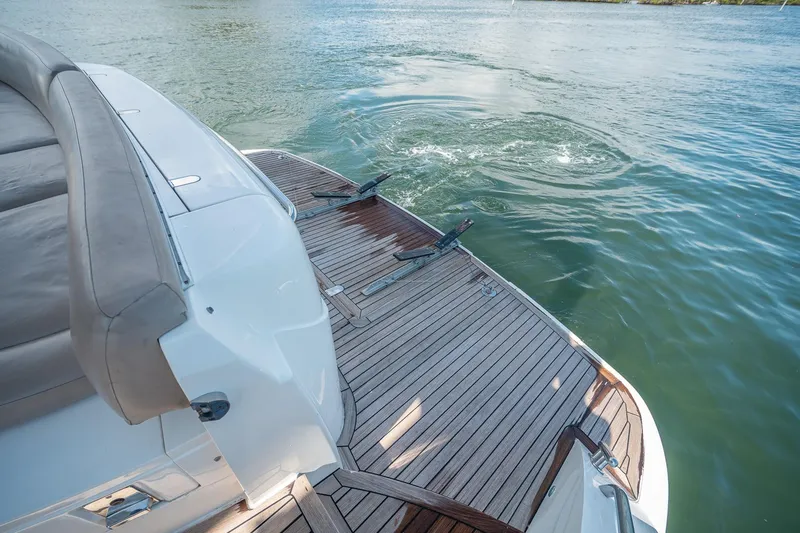 Slide: The Image of Luxury Princess F54 yacht's teak swim platform on serene water, 2009 model. - 95