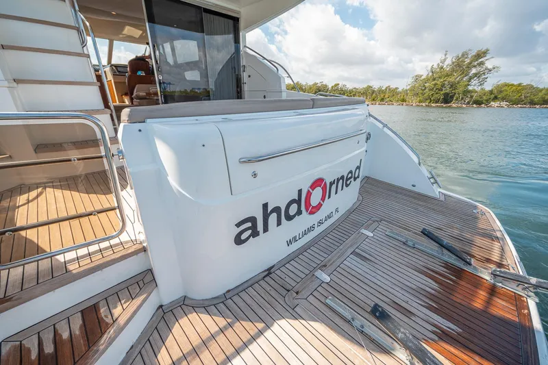 Slide: The Image of Luxury Princess F54 yacht, 2009 model, docked with wooden deck and scenic water view. - 98