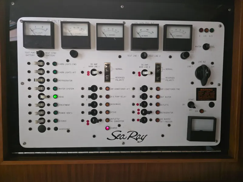 Slide: The Image of Control panel of a 1987 Sea Ray 390 Express Cruiser with gauges and switches. - 17