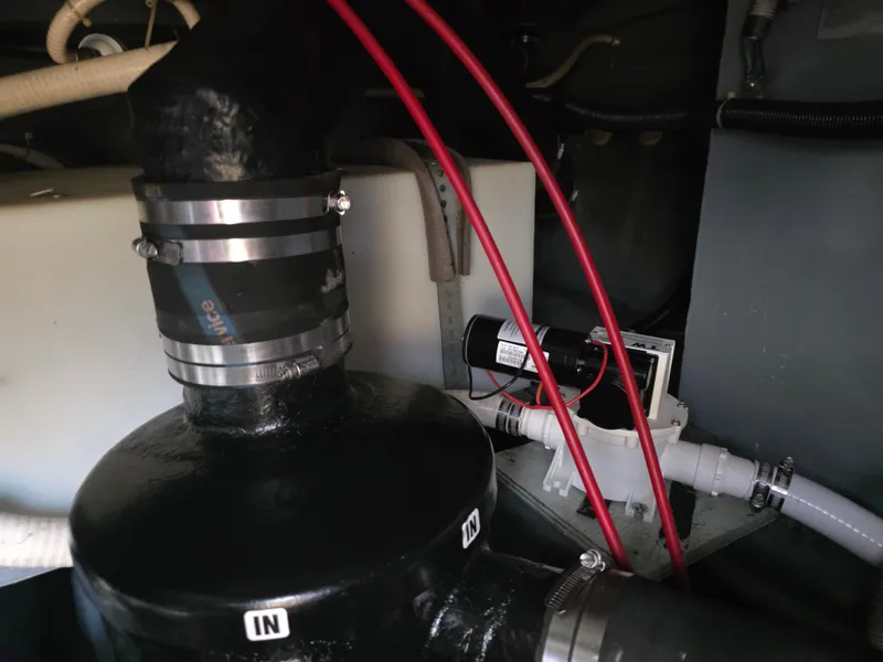 Slide: The Image of Engine compartment of 1987 Sea Ray 390 Express Cruiser with visible hoses and fittings. - 23