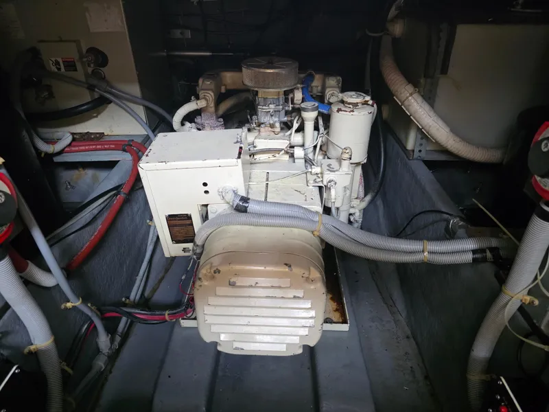Slide: The Image of Engine room of a 1987 Sea Ray 390 Express Cruiser with visible machinery and hoses. - 25