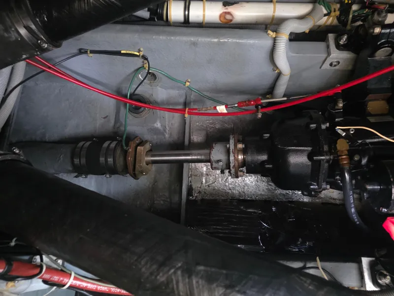 Slide: The Image of Engine compartment of a 1987 Sea Ray 390 Express Cruiser with visible wiring and components. - 28