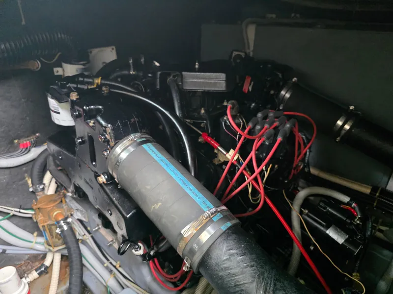 Slide: The Image of Engine compartment of 1987 Sea Ray 390 Express Cruiser with visible hoses and wiring. - 30