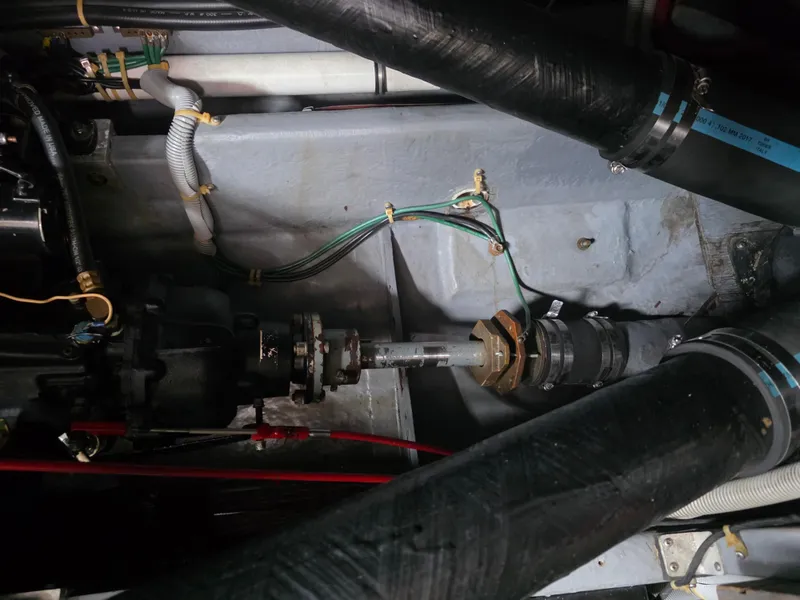 Slide: The Image of Engine compartment of 1987 Sea Ray 390 Express Cruiser with visible mechanical components. - 33