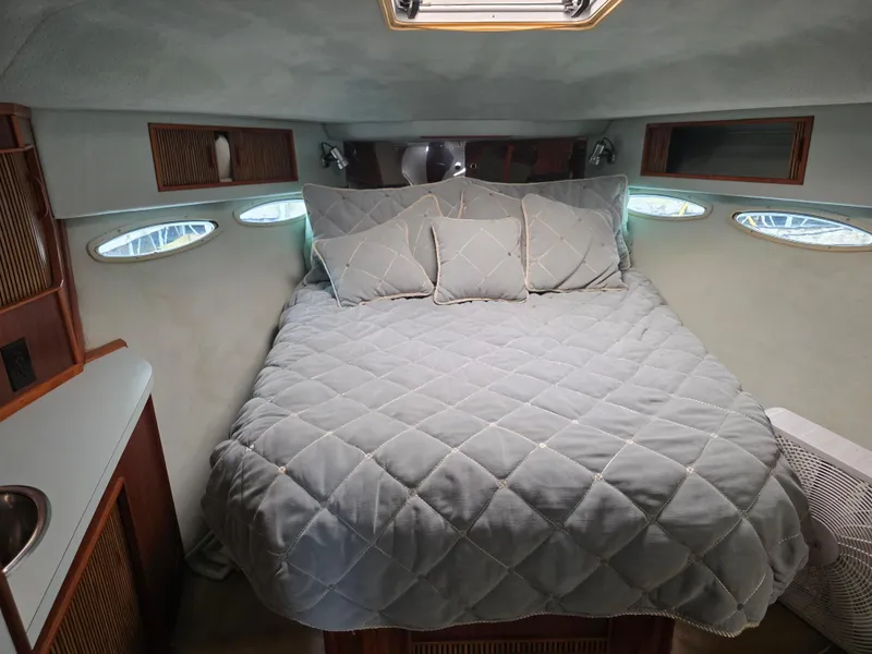 Slide: The Image of Cozy cabin interior of 1987 Sea Ray 390 Express Cruiser with a comfortable bed. - 44